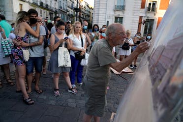 Spanish artist Antonio Lopez works during a session to paint the famous Puerta del Sol square in Madrid, Spain, August 5, 2021. Picture taken August 5, 2021. REUTERS/Juan Medina