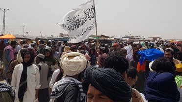 People gather around a Taliban flag as they wait for relatives released from jail in Afghanistan following an 'amnesty' by the Taliban, near the Pakistan-Afghanistan border crossing point in Chaman. (File Photo: Reuters)