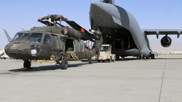 Aerial porters work with maintainers to load a UH-60L Blackhawk helicopter into a US Air Force C-17 Globemaster III during the withdrawal of American forces in Afghanistan, June 16, 2021. (US Army/Sgt. 1st Class Corey Vandiver/Handout via Reuters)