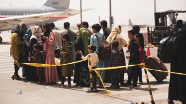 Civilians prepare to board a plane during an evacuation at Hamid Karzai International Airport, Kabul, Afghanistan August 18, 2021. (Reuters)