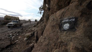 Shi'ite Houthi militiamen drive a patrol truck past a Ansar al-Sharia flag painted on the side of a hill, along a road in Almnash, the main stronghold of Ansar al-Sharia, in Rada November 22, 2014. Shi'ite Houthi fighters recently managed to enter the area, which had long been the main stronghold of Ansar al-Sharia, the local wing of Al Qaeda in the Arabian Peninsula (AQAP). Picture taken November 22, 2014. REUTERS/Mohamed al-Sayaghi (YEMEN - Tags: CIVIL UNREST TPX IMAGES OF THE DAY CONFLICT)