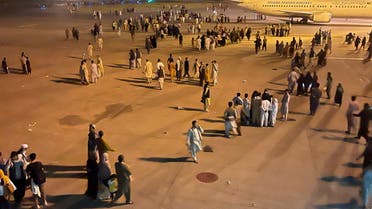 An undated amateur picture obtained by Reuters on August 19, 2021 shows people walking on the tarmac of the airport in Kabul, Afghanistan. (Reuters)