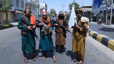 Taliban fighters stand guard along a road near the site of an Ashura procession which is held to mark the death of Imam Hussein, the grandson of Prophet Mohammad, along a road in Herat on August 19, 2021. (AFP)