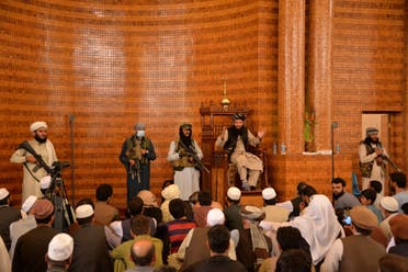 Armed Taliban fighters stand next an Imam during Friday prayers at the Abdul Rahman Mosque in Kabul on August 20, 2021. (AFP)
