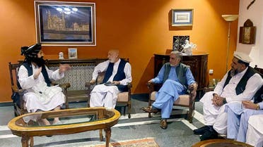 Former Afghan President Hamid Karzai, accompanied by the old government's main peace envoy, Abdullah Abdullah, sits for talks with members of the Taliban delegation in this undated handout uploaded August 19, 2021. (Reuters)
