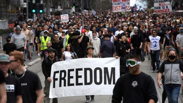 Protesters march through the streets during an anti-lockdown rally in Melbourne on August 21, 2021 as the city experiences it's sixth lockdown while it battle an outbreak of the Delta variant of coronavirus. (AFP)