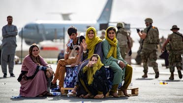 Evacuee children wait for the next flight after being manifested at Hamid Karzai International Airport, in Kabul, Afghanistan, August 19, 2021. (Reuters)