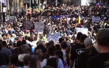 Protesters march through the streets during an anti-lockdown rally in Melbourne on August 21, 2021 as the city experiences it's sixth lockdown while it battle an outbreak of the Delta variant of coronavirus. (AFP)