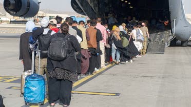 FILE PHOTO: Evacuees assemble before boarding a C-17 Globemaster III during an evacuation at Hamid Karzai International Airport, Afghanistan, August 18, 2021. Picture taken August 18, 2021. U.S. Marine Corps/Lance Cpl. Nicholas Guevara/Handout via REUTERS/File Photo