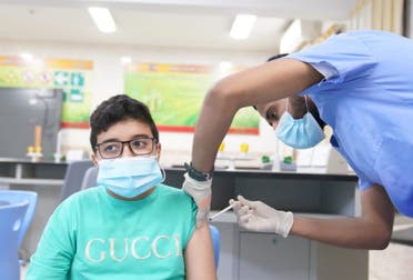 A young boy receives a COVID-19 vaccine in Saudi Arabia. (Photo Courtesy: Ministry of Education)