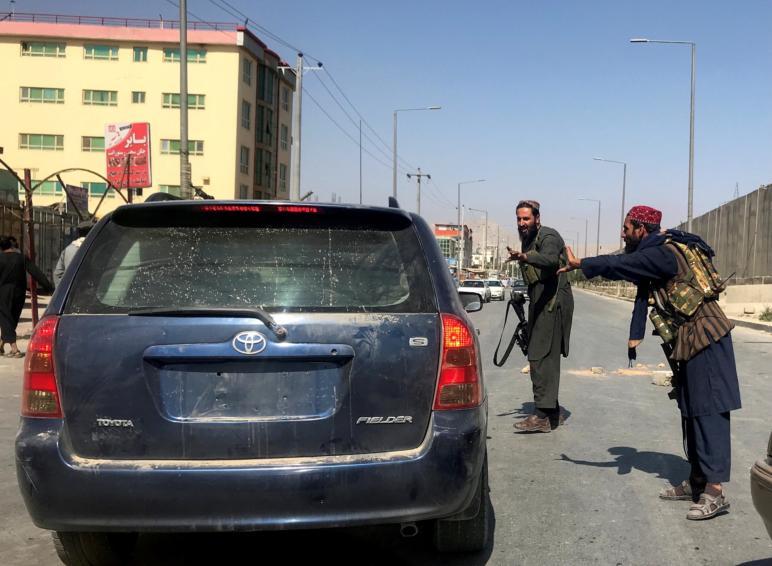 FILE PHOTO: Members of Taliban forces gesture as they check a vehicle on a street in Kabul, Afghanistan, August 16, 2021. (Reuters)