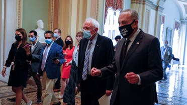 Senator Sanders walks with Senate Minority Leader Schumer as they depart meeting on Democratic budget resolution on Capitol Hill in Washington. (Reuters)