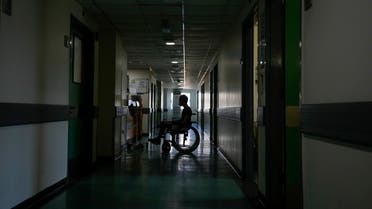 A patient attends in a corridor of the government-run Rafik Hariri University Hospital during a power outage in Beirut, Lebanon, Wednesday, Aug. 11, 2021. (AP/Hassan Ammar)