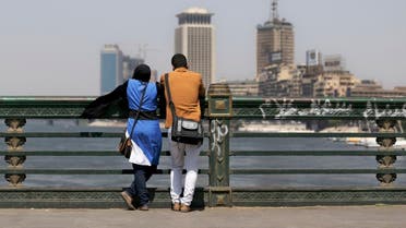 A couple of Egyptians share a moment as they overlook the Nile river from a bridge in Cairo, Egypt, Monday, Sept. 9, 2013. (AP)