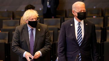 Britain's Prime Minister Boris Johnson stands next to US President Joe Biden during a plenary session at a NATO summit in Brussels, Belgium, June 14, 2021. (Reuters)