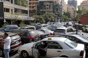 Lebanese wait in a queue outside a closed petrol station in Beirut’s Hamra district on August 20, 2021. (Anwar Amro/AFP)