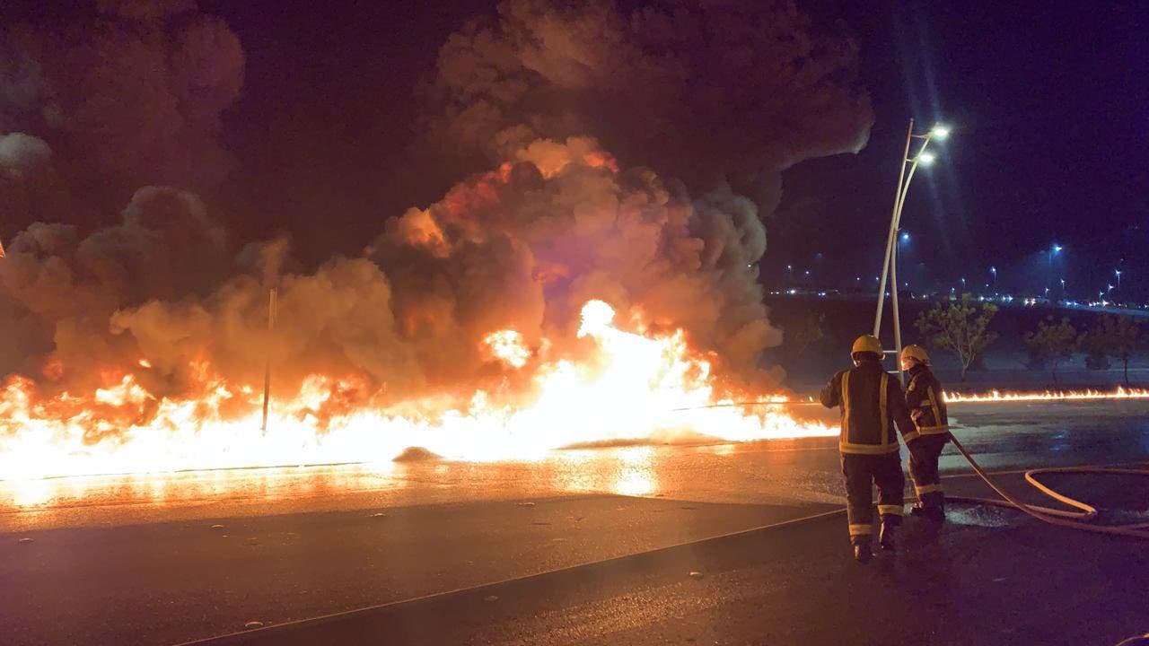 A photo published August 24 2021 showing firefighters attempting to extinguish the blaze on the Mecca-Jeddah highway after a petroleum truck was involved in a traffic accident. (Twitter)