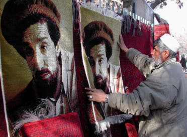 An Afghan man sells carpets with the picture of assassinated Northern Alliance leader Ahmad Shah Massoud on them in a Kabul market on January 24, 2002. (Reuters)