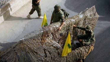 Hezbollah fighters stand atop a car mounted with a mock rocket, as they parade during a rally to mark the seventh day of Ashoura, in the southern village of Seksakiyeh, Lebanon. (File Photo: AP)
