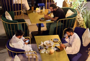 People sit at David Burke's restaurant, in The Zone restaurant complex, in Riyadh, Saudi Arabia. (Reuters)