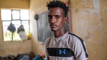 Tilahun Alemu, a youngster displaced by fighting in northern Ethiopia, is portrayed in a classroom at the Addis Fana School where he is temporary sheltered, in the city of Dessie, Ethiopia, on August 23, 2021. (AFP)
