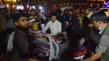 Volunteers and medical staff bring an injured man on a stretcher for treatment after two powerful explosions, which killed at least six people, outside the airport in Kabul on August 26, 2021. (AFP)
