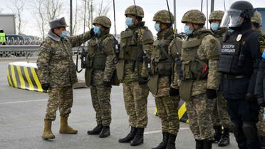 Kazakhstan's army and police servicemen in protective masks line up at a checkpoint, set up to lock down Nur-Sultan to prevent the spread of coronavirus disease (COVID-19), on the outskirts of Nur-Sultan, Kazakhstan March 19, 2020. (Reuters)