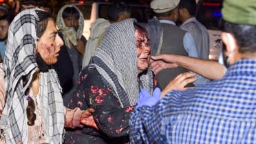 Wounded women arrive at a hospital for treatment after two blasts, which killed at least five and wounded a dozen, outside the airport in Kabul on August 26, 2021. (AFP)