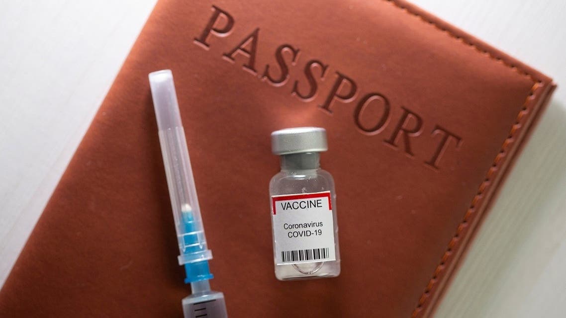 A syringe and a vial labelled coronavirus disease vaccine are placed on a passport in this illustration taken April 27, 2021. (Reuters)