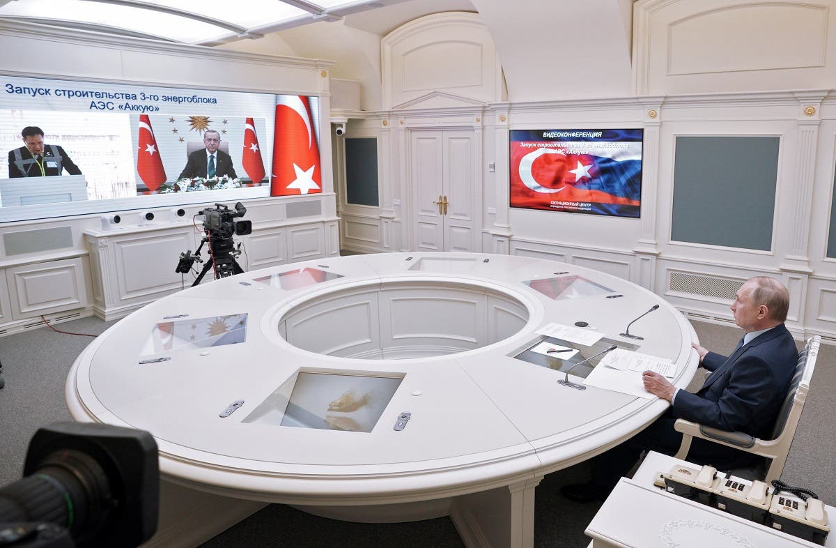 Russian President Vladimir Putin looks at a screen showing Turkish President Tayyip Erdogan as he attends a foundation-laying ceremony for the third reactor of the Akkuyu nuclear plant in Turkey, via a video link in Moscow, Russia, on March 10, 2021. (Reuters)