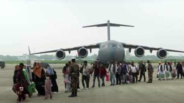 People evacuated from Afghanistan get off a plane in Ghaziabad, Uttar Pradesh, India, on August 22, 2021 in this still image taken from video. (Reuters)