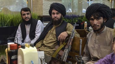 Taliban fighters wait for their meals to be served as they lunch at a restaurant in Kabul on August 26, 2021 after Taliban's military takeover following the US troop withdrawal. (AFP)