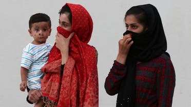 This picture taken during a media visit organised by the Qatari authorities on August 21, 2021, shows Afghan women and a child inside a villa complex near the centre of the Qatari capital Doha. (AFP)