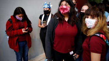 Students wearing protective masks arrive for classes on the first day of school in Miami-Dade County, Aug. 23, 2021. (Reuters)
