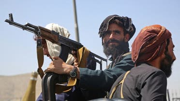 Taliban fighters stand guard in a vehicle along the roadside in Kabul on August 16, 2021. (AFP)