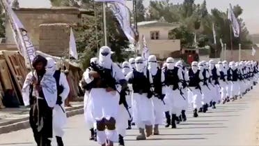 Taliban fighters march in uniforms on the street in Qalat, Zabul Province, Afghanistan, in this still image taken from social media video uploaded August 19, 2021. (Reuters)
