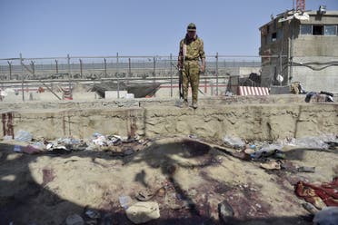 A Taliban fighter stands guard at the site of the August 26 twin suicide bombs, which killed scores of people including 13 US troops, at Kabul airport on August 27, 2021. (File photo: AFP)
