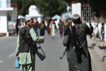 Taliban fighters walk at the main entrance gate of Kabul airport in Kabul on August 28, 2021, following the Taliban stunning military takeover of Afghanistan. (AFP)