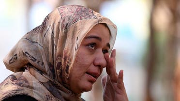 Ghazaal Habibyar, one of the 457 Afghan evacuees housed in Albania, wipes her eye as she speaks during an interview with The Associated Press, Sunday, Aug. 29, 2021. (AP)