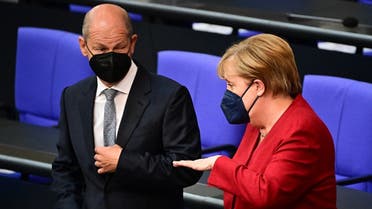 German Finance Minister, Vice-Chancellor and the Social Democrats (SPD) candidate for Chancellor Olaf Scholz (L) and German Chancellor Angela Merkel talk ahead a plenary session at the German lower house of parliament Bundestag in Berlin on August 25, 2021. (Tobias Schwarz/AFP)