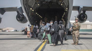 Families begin to board a US Air Force Boeing C-17 Globemaster III during an evacuation at Hamid Karzai International Airport, Kabul, Afghanistan, August 23, 2021. (AFP)