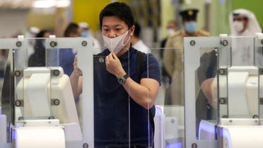 A Japanese journalist checks out the new face and iris-recognition procedures, during a media tour at Dubai airport, United Arab Emirates, Sunday, March 7, 2021. (AP)