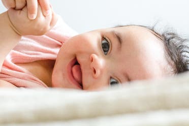 Baby laughing. (Unsplash, Daniel Thomas)
