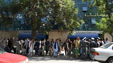 Bank account holders gather outside a closed bank building in Kabul on August 28, 2021, following the Taliban's stunning military takeover of Afghanistan. (AFP)