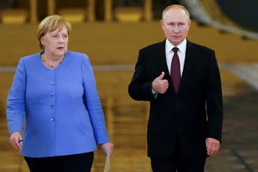 Russian President Vladimir Putin and German Chancellor Angela Merkel enter a hall during a news conference following their talks at the Kremlin in Moscow, Russia, on August 20, 2021. (Reuters)