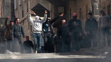 File photo of anti-Syrian government protesters flashing Victory signs as they protest in the southern city of Daraa, Syria. (AP)
