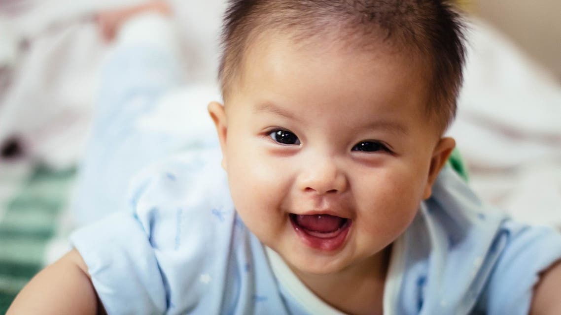 Baby laughing. (Unsplash, Jason Sung)