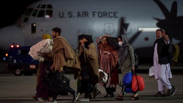 Afghan refugees, fleeing the Afghan capital Kabul, exit an US air force plane upon their arrival at Pristina International airport near Pristina on August 29, 2021. Kosovo has offered to take in temporarily thousands of Afghan refugees evacuated by US forces from Kabul until their asylum claims are processed.