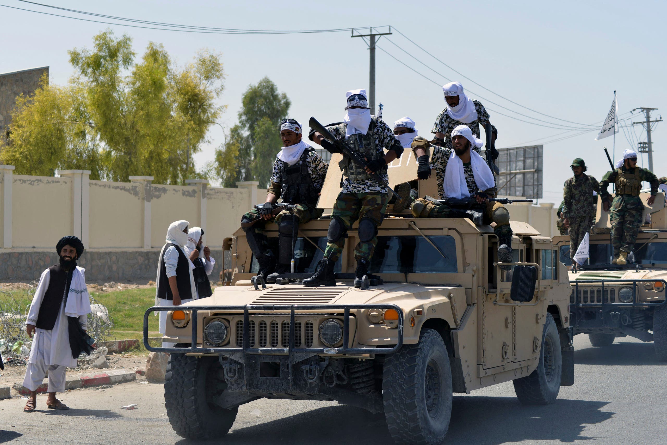 Taliban fighters stand on an armoured vehicle before parading along a road to celebrate after the US pulled all its troops out of Afghanistan, in Kandahar on September 1, 2021 following the Taliban’s military takeover of the country. (AFP)