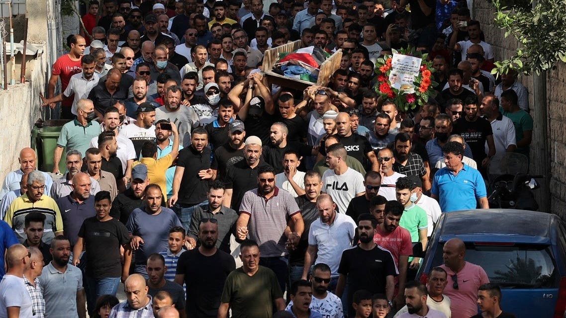 Mourners carry the body of Palestinian Raed Jadallah, who according to the Palestinian health ministry was shot dead by Israeli forces overnight, during his funeral near the West Bank city of Ramallah, on September 1, 2021. (Abbas Momani/AFP)